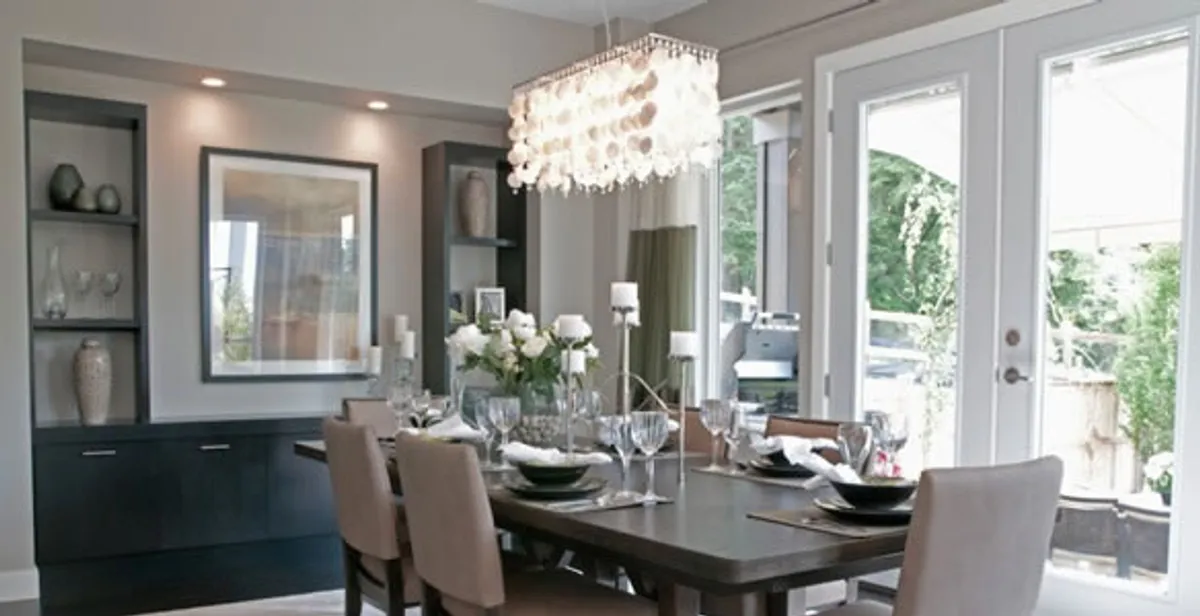 Elegant dining room chandelier installation above table in Boston, MA