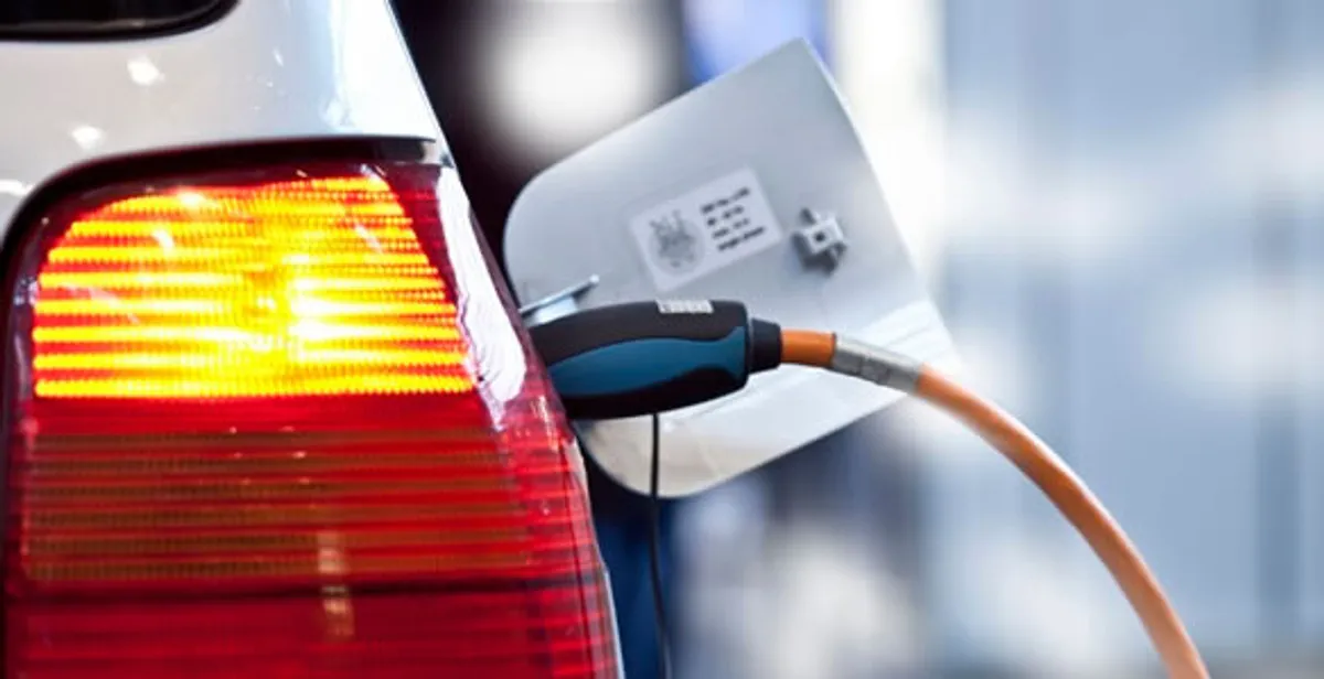 Electric car plugged into EV charger after professional installation in Boston, MA