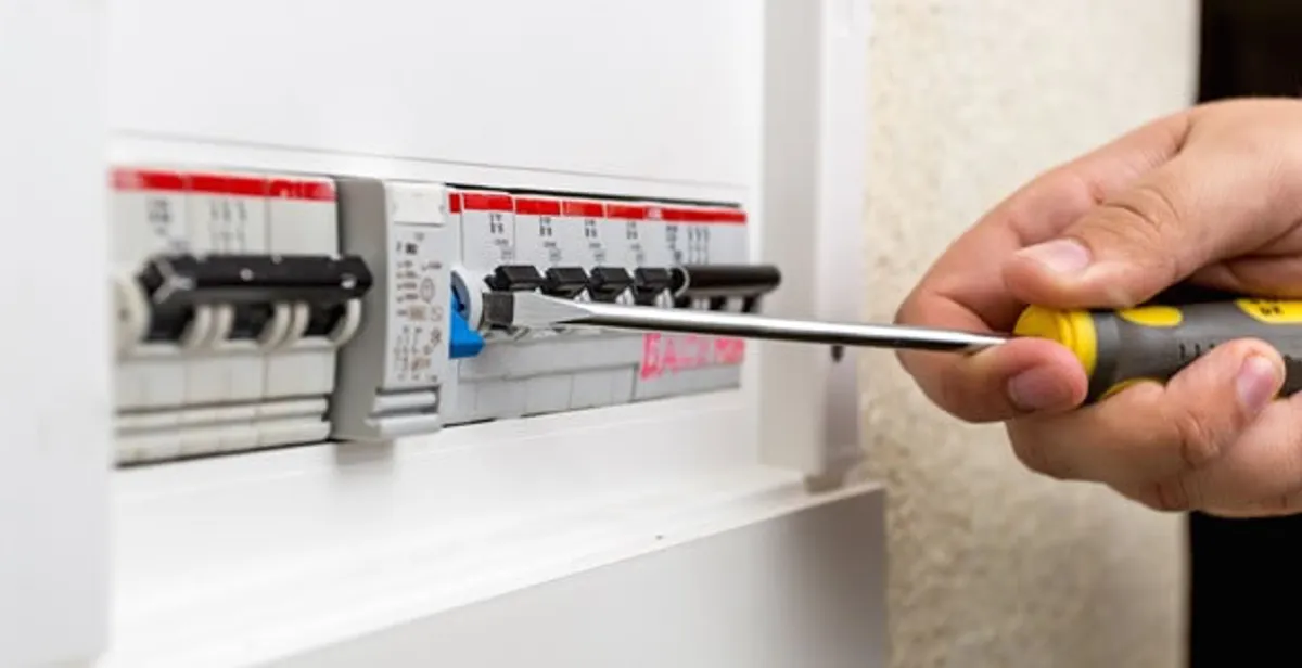 electrical panel upgrade service showing technician adjusting circuit breakers during system upgrade in Boston, MA