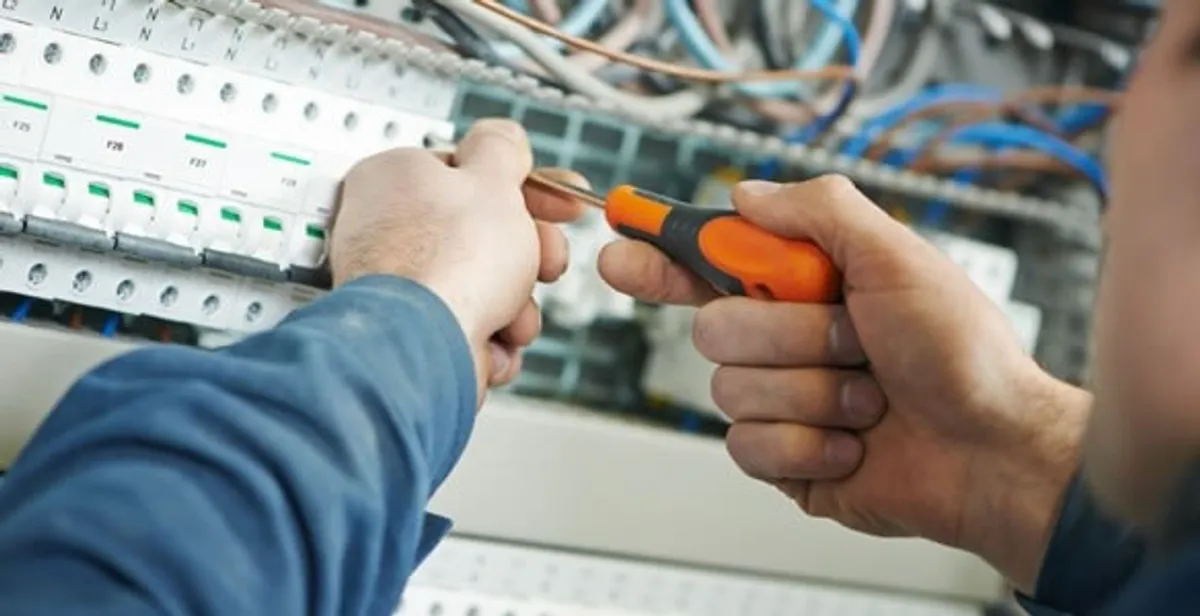 electrical service showing licensed electrician performing electrical panel maintenance and adjustments in Boston, MA
