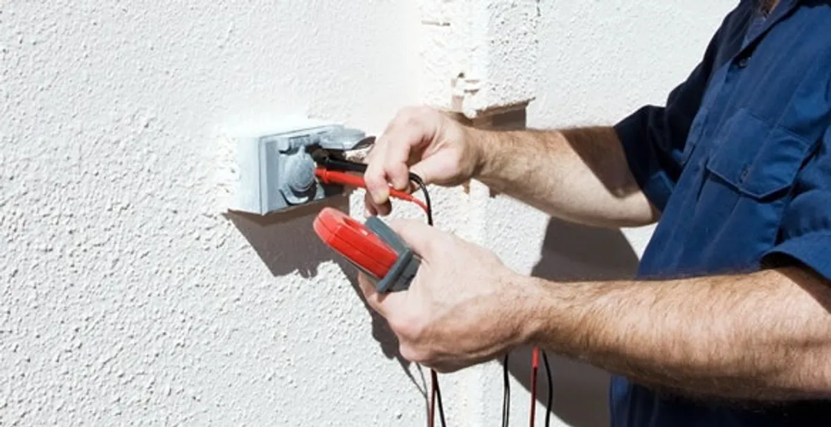 Electrician performing home electrical outlet and wiring inspection in Boston, MA