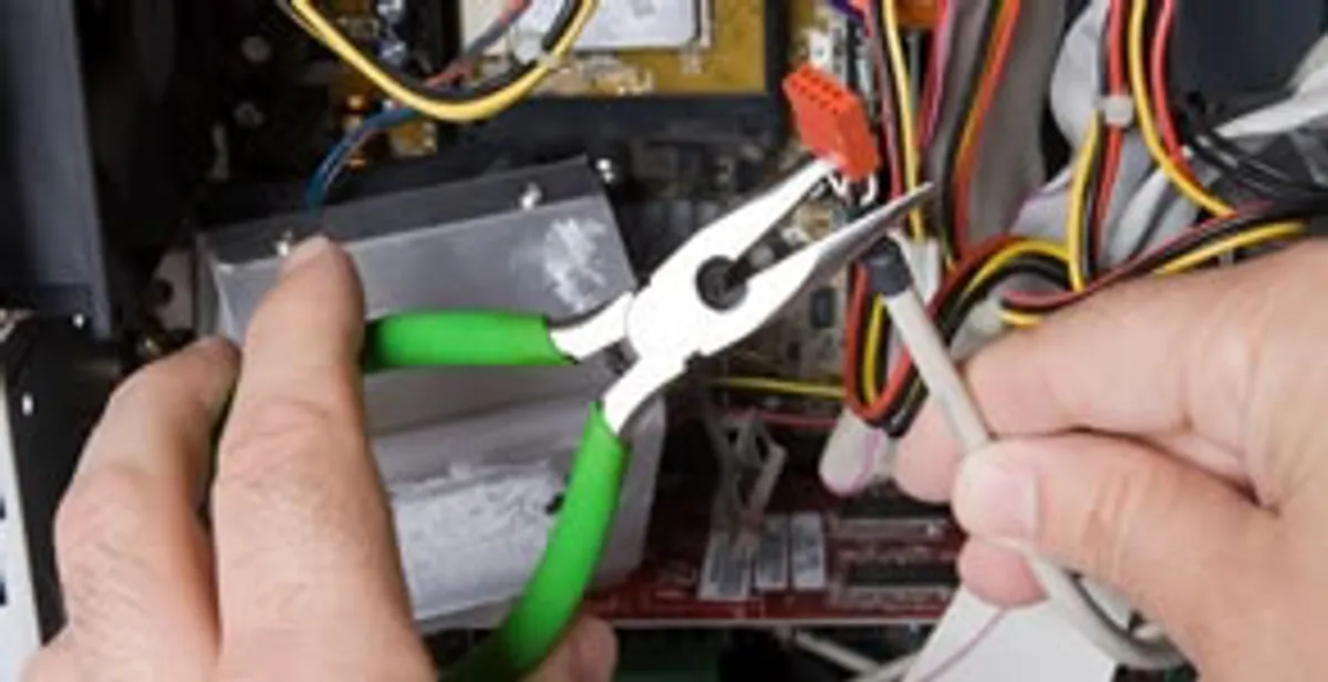 Licensed electrical contractor performing electrical repair with tools in Roxbury Crossing, MA