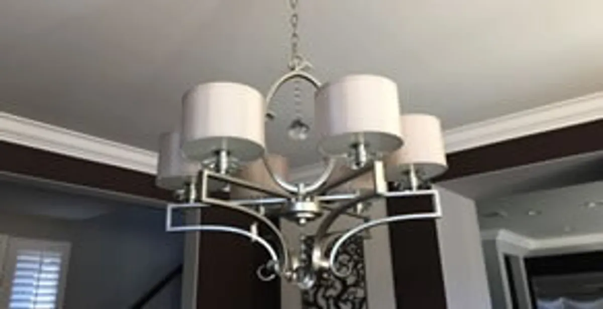 Modern chandelier installation with multiple light fixtures in Boston, MA