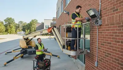 Electrician installing security lights on a Boston, MA home