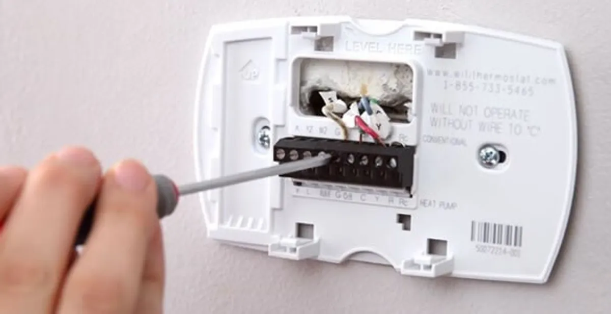 Thermostat installation service with proper wiring and secure wall mounting in Boston, MA